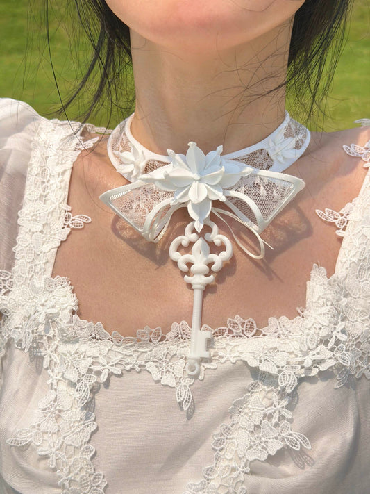 White 3D printed key choker with lace-inlaid bow collar — close-up